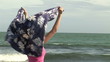Woman holding her scarf on the wind