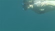 Young woman underwater breathing using a snorkel