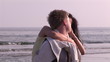 Video: Young man on the beach turning with girlfriend on his back Young man on the beach turning with girlfriend on his back