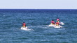 Group of friends doing some jetski in the sea during holidays