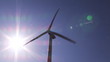 View of a wind turbine turning against beautiful blue sky