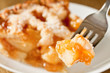 Bite of delicious rustic apple pie on a fork Bite of delicious rustic apple pie on a fork