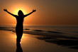 Young adult female with arms wide open on a sunset Young adult female with arms wide open on a sunset