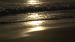 Close up of  waves with foam at sunset on the beach