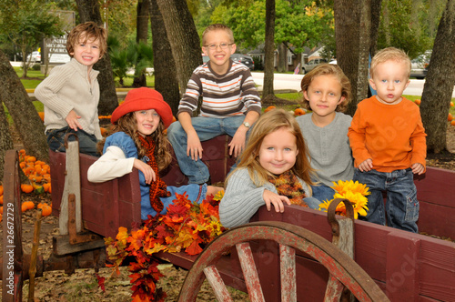 Photo: Kids in wagon in pumpkin patch in the fall Kids in wagon in pumpkin patch in the fall