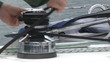 Close up of a man winding a rope in his boat