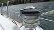 Close up of a sailor unwinding a rope in his boat