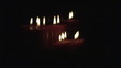 Scrolling up showing  lit candles in the dark