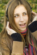 Woman with headphones in autumn park
