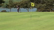 Video: Happy golfer putting the ball in the fifth hole Happy golfer putting the ball in the fifth hole