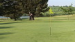 Golfer on the green doing the fourth hole