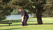 Video: Golfer swinging on the green during a sunny day Golfer swinging on the green during a sunny day