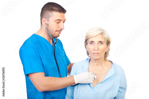 Photo: Doctor man assess senior woman Doctor man assess senior woman