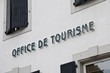 French tourism office sign on a white wall French tourism office sign on a white wall