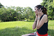 a beautiful girl listening to music in the park a beautiful girl listening to music in the park