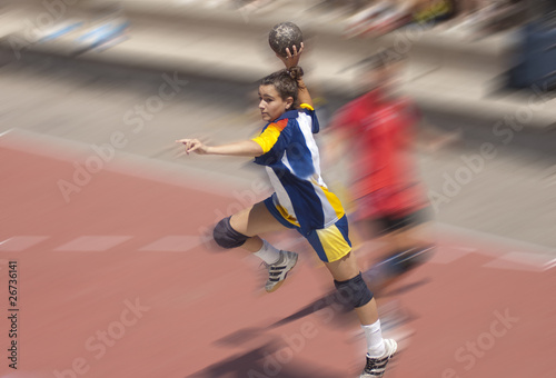 Photo: Handball player jumping with the ball Handball player jumping with the ball