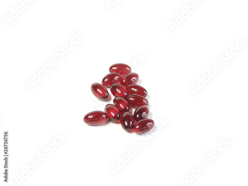 Photo: Red pills isolated on white background Red pills isolated on white background