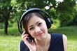 Beautiful girl listening music in the park Beautiful girl listening music in the park