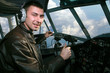 Young pilot in booth of the airplane