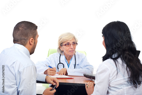 Photo: Senior doctor offers medical advices to a couple Senior doctor offers medical advices to a couple