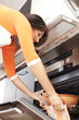 Woman opening the kitchen oven