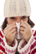 woman sneezing to a tissue woman sneezing to a tissue