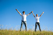 couple standing together with hands up on nature couple standing together with hands up on nature