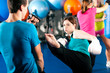Female kick boxer with trainer in sparring
