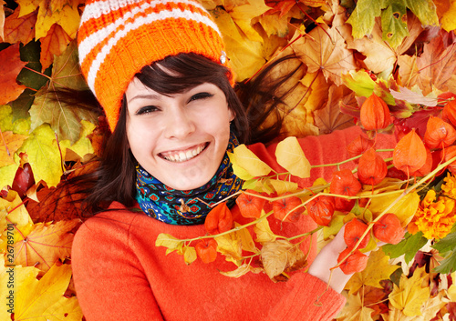 Photo: Young woman in autumn orange leaves. Young woman in autumn orange leaves.