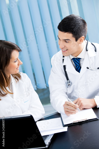 Photo: Two medical people working at office Two medical people working at office