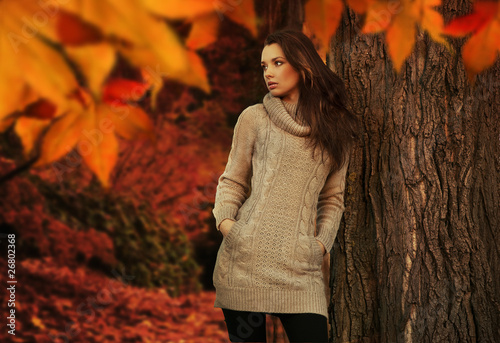Photo: Young woman in a romantic autumn scenery Young woman in a romantic autumn scenery