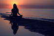 Woman doing yoga at sunset Woman doing yoga at sunset