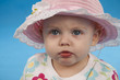 Small lovely girl on a blue background.