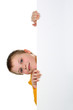 Small boy looks out of blank billboard isolated on white