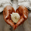 Henna hands holding a flower