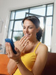 amazed woman holding cellphone
