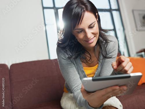 Photo: woman using tablet pc woman using tablet pc