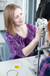 optometry concept - pretty young woman having her eyes examined optometry concept - pretty young woman having her eyes examined