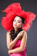 Dreaming beautiful brunette woman in red tulle hat Dreaming beautiful brunette woman in red tulle hat