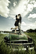 Photo: Young Couple Kissing on Old Car. Young Couple Kissing on Old Car.