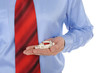 Red and white tablets in male hands