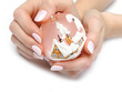 Photo: Beautiful hand with perfect nail pink manicure and christmas tre Beautiful hand with perfect nail pink manicure and christmas tre