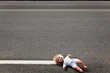 Photo: doll leave on a highway lane doll leave on a highway lane