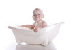 Boy in white bath tub on white background