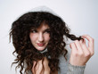 Photo: Young girl in hood playing with her hair Young girl in hood playing with her hair