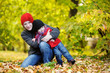 Young mother and her toddler girl in autumn