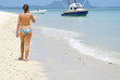 Topless woman walking on the beach