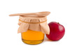Honey in jar wooden spoon red apple isolated.