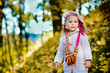 Pretty little girl with bagels in autumn park Pretty little girl with bagels in autumn park
