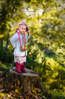 Pretty little girl with bagels in autumn park Pretty little girl with bagels in autumn park